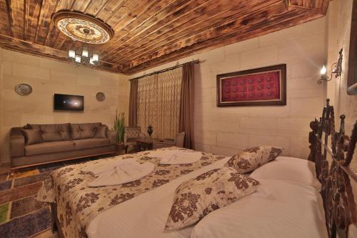 a bedroom with a bed and a couch at Caravanserai Inn Hotel in Goreme