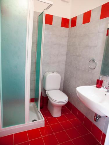 a bathroom with a toilet and a shower and a sink at Bouganville House in Zafferana Etnea