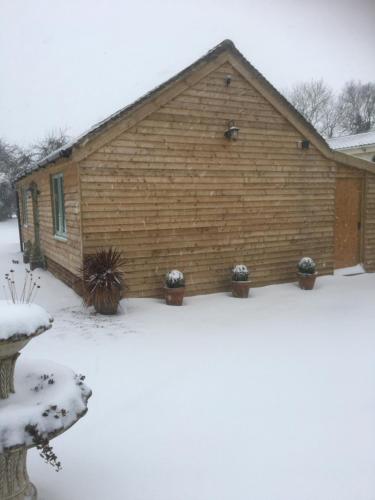 a building with snow in front of it at Little Banks Barn in Ringwood
