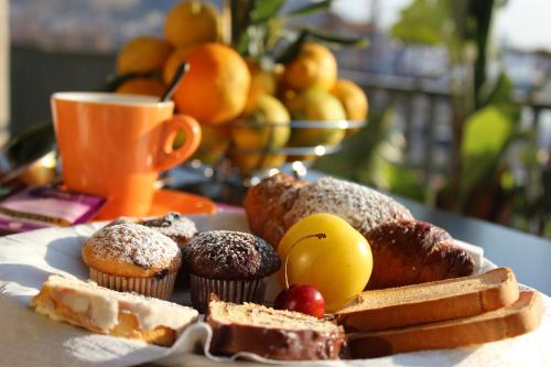 a plate of pastries and bread and a cup of coffee at President Hotel Palermo in Palermo