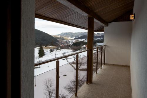 a balcony with a view of a snow covered mountain at Guest House Panorama in Gela