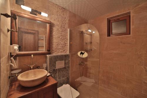 a bathroom with a sink and a shower at Caravanserai Inn Hotel in Goreme
