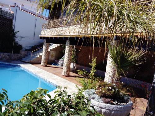 a house with a swimming pool and a bridge at Villa con piscina privada in Torremolinos