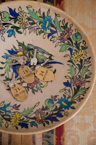 a clock with a floral design on it with price tags at Hotel Santa Marina Antica Foresteria in Santa Marina Salina
