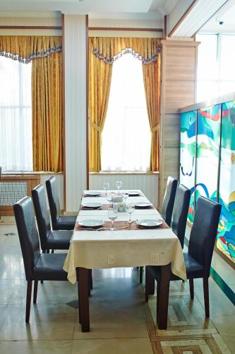 a dining room with a table with chairs at Grand Nakhchivan Hotel in Naxçıvan