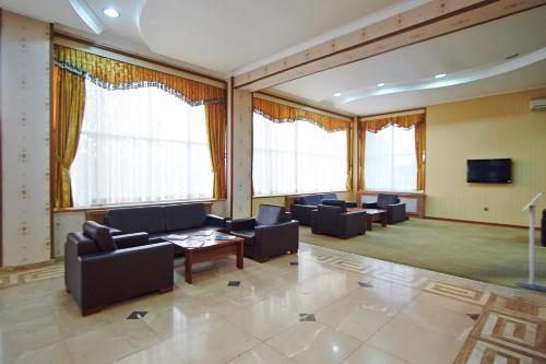 a large living room with couches and a tv at Grand Nakhchivan Hotel in Naxçıvan