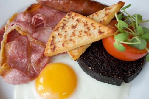 a plate of food with eggs ham and toast at Balnearn House in Aberfeldy