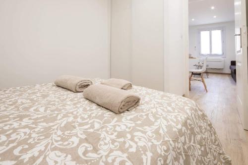 a bedroom with a bed with two pillows on it at Au coeur du Panier - Vieux Port in Marseille