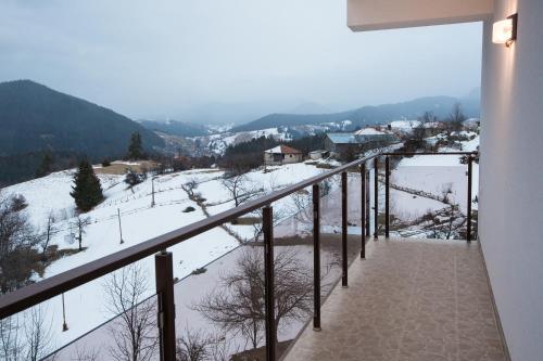 a balcony with a view of a snow covered mountain at Guest House Panorama in Gela