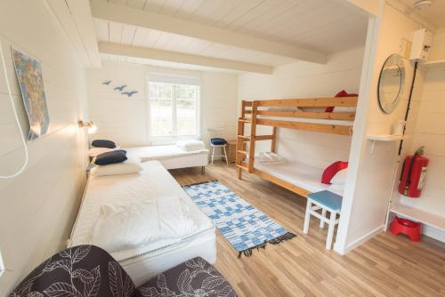 a small room with a bunk bed and a bunk bed at Hasselö Hostel in Hasselö