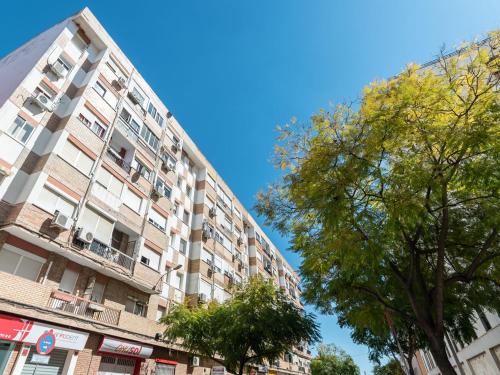 a tall apartment building with trees in front of it at Apartamento Luis de Vargas in Huelva