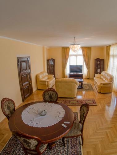 a living room with a table and chairs at Villa Ramonte in Cetinje