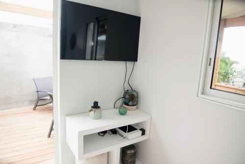 a living room with a tv on a wall at thomlocation in Saint-Paul