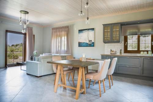 a kitchen and dining room with a table and chairs at Cephalonian Countryside Villa in Divarata