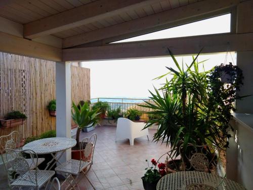 a patio with a table and chairs and plants at PortAtenea - Atenea Collection in Agrigento