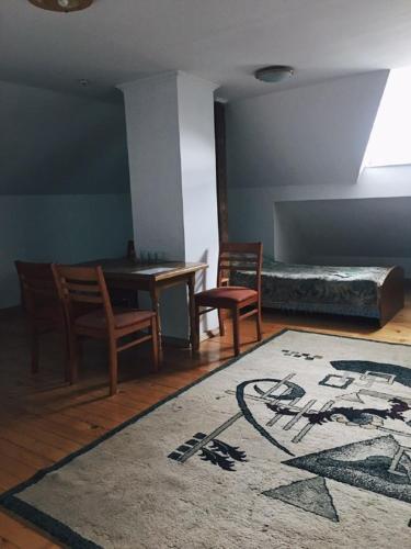 a bedroom with a bed and a table and chairs at Lemon in Drohobytsch