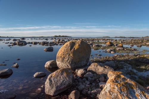 a group of rocks in a body of water at Hasselö Hostel in Hasselö