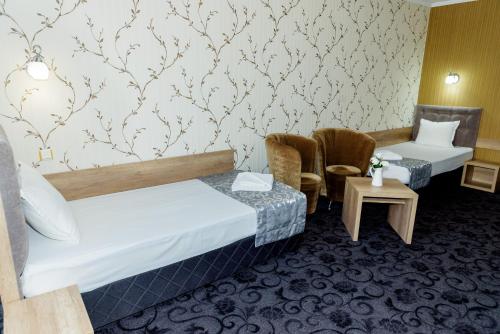 מיטה או מיטות בחדר ב-Family Hotel Prestige