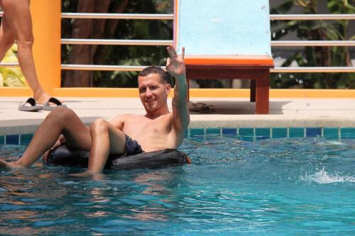 a man in the water on a raft in a swimming pool at Coco Palm Hotel Koh tao in Koh Tao