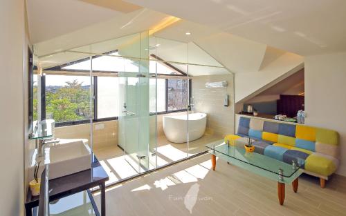 a bathroom with a tub and a sink and a shower at 宜蘭莫內花園城堡 in Wujie