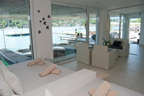 a bedroom with a bed with two towels on it at Seehotel Europa Resort in Velden am Wörthersee