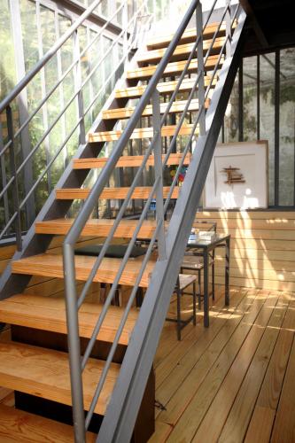 a metal staircase in a room with a table at RVA - Gustave Eiffel Apartments in Porto