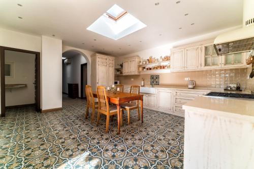 a kitchen with a wooden table and chairs in it at Family hotel Al- Ana Marbella in Estepona