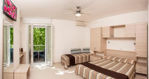a living room with a couch and a ceiling fan at Villa Marcolini in Cattolica