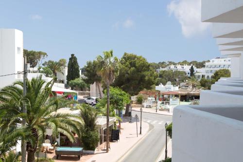 a view of a city street with palm trees at Gavimar Cala Gran Hotel and Apartments in Cala d´Or