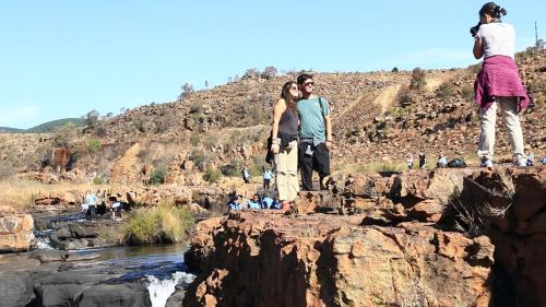 a group of people standing on the rocks near a river at Jock-Sabie Lodge in Sabie