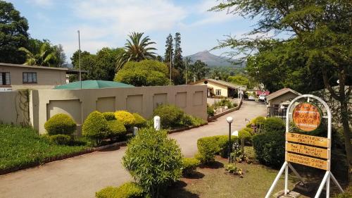 a house with a sign in front of a driveway at Jock-Sabie Lodge in Sabie