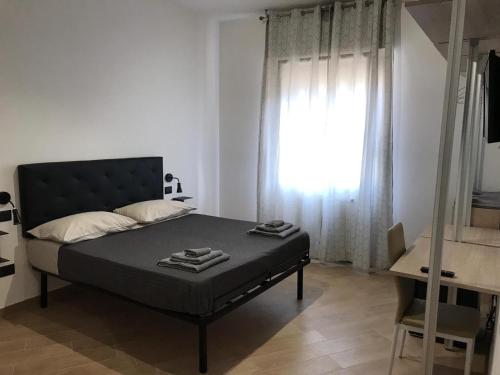 a bedroom with a bed and a window at Riva Reno 4 Rooms in Bologna