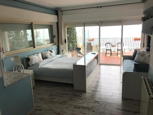 a bedroom with a bed and a living room at B&B La Terrazza Sul Mare Taormina in Taormina