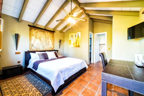 a bedroom with a king sized bed and a flat screen tv at Family hotel Al- Ana Marbella in Estepona