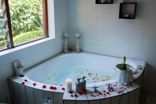 a bath tub with candles and flowers in a bathroom at Rustic Butler B&B in White River