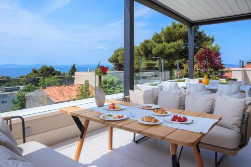 a table with plates of food on a balcony at Alba Residence in Split