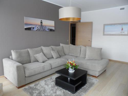 a living room with a couch and a table at Staapli apartment in Tallinn