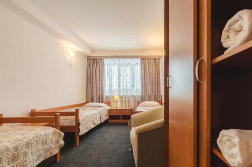 a hotel room with two beds and a window at Oazis Hotel in Pskov