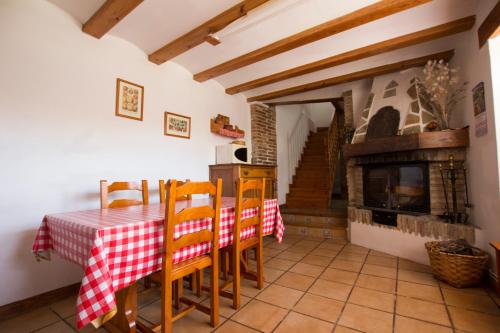 a dining room with a table and a fireplace at Casa Villazón I - Camino de Santiago in Muruzábal