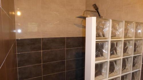 a bathroom with a rack of wine glasses at Villa l'Icône in Cassis