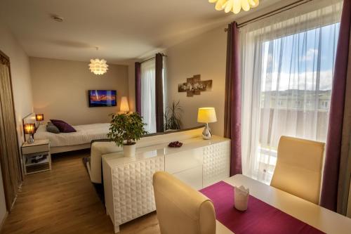 a living room with a bed and a table and chairs at Luxurious, lovely and romantic apartment in Tabor in Tábor