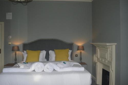 a bedroom with a bed with towels on it at The Royal Oak in Woodford