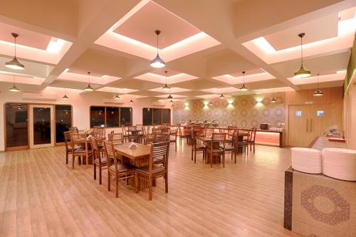 a large dining room with tables and chairs at The Byke Old Anchor Beach Resort & Spa in Cavelossim