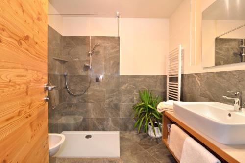 a bathroom with a shower and a sink at Appartements Mayrhof in Bressanone