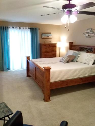 a bedroom with a large bed and a ceiling fan at Bayou Beauty in Ocean Springs