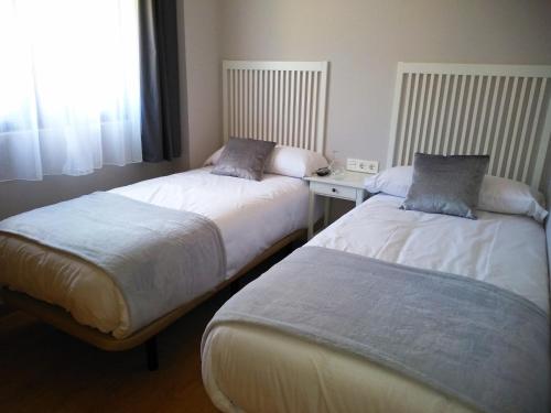 Кровать или кровати в номере Apartamentos Prestin