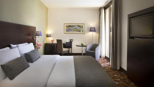 Voodi või voodid majutusasutuse Babylon Rotana Hotel toas
