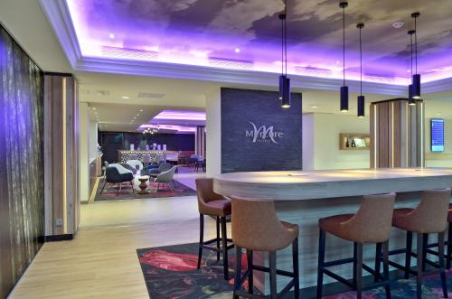 a bar in a hotel lobby with a bar stools at Mercure Hotel Koblenz in Koblenz