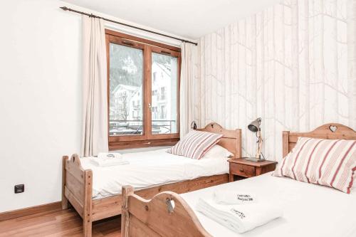 Ένα ή περισσότερα κρεβάτια σε δωμάτιο στο Apartment Balmat - Chamonix All Year