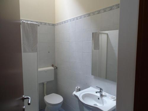 a white bathroom with a toilet and a sink at b&b new antico palazzo in Parabita